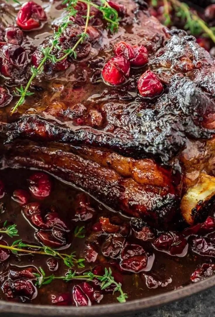 Plate of roast beef with cranberry sauce and balsamic glaze.